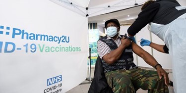 Man receiving vaccine at a Pharmacy2U vaccination centre