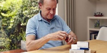 Man sorting through his medication