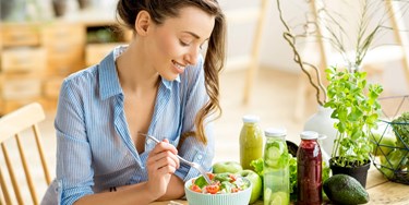 Woman eating healthy greens