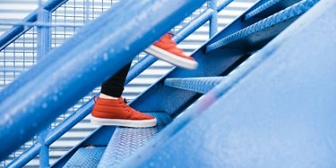 Close up on feet of person climbing stairs