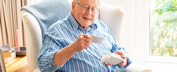 Older man opening his medication
